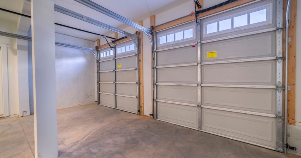 Property owner comparing garage door styles and insulation options for coastal home replacement