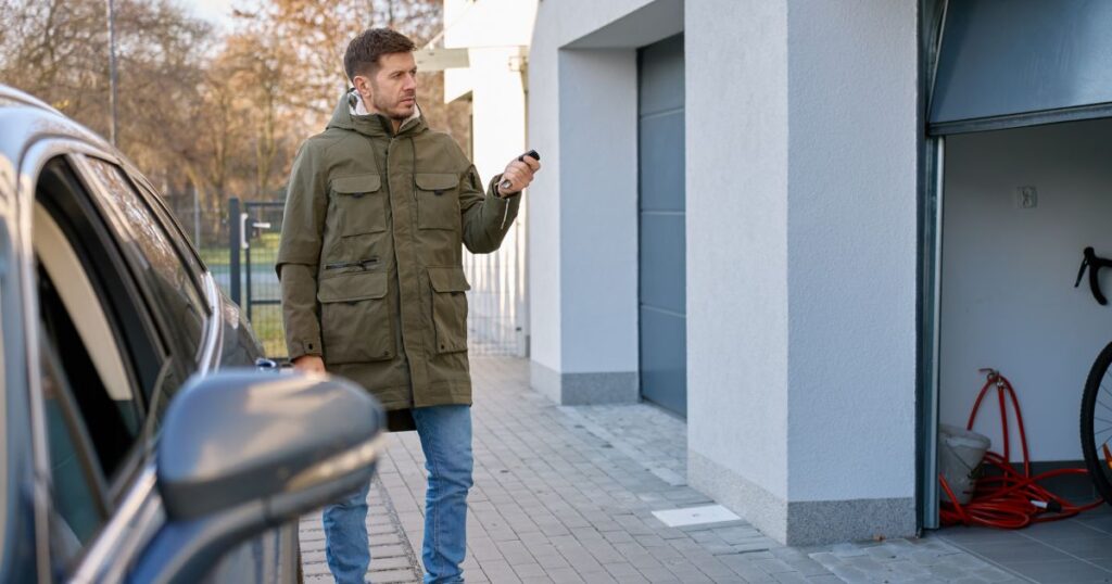 Technician evaluating garage door material and fit for long-term residential performance