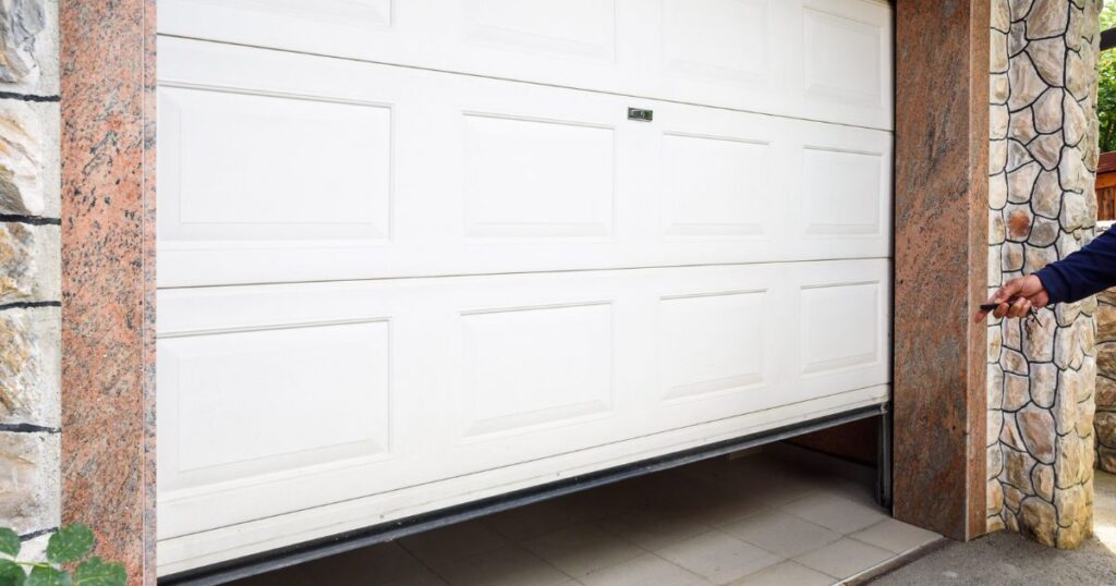 Specialist assessing garage door material options for durability and exterior appearance