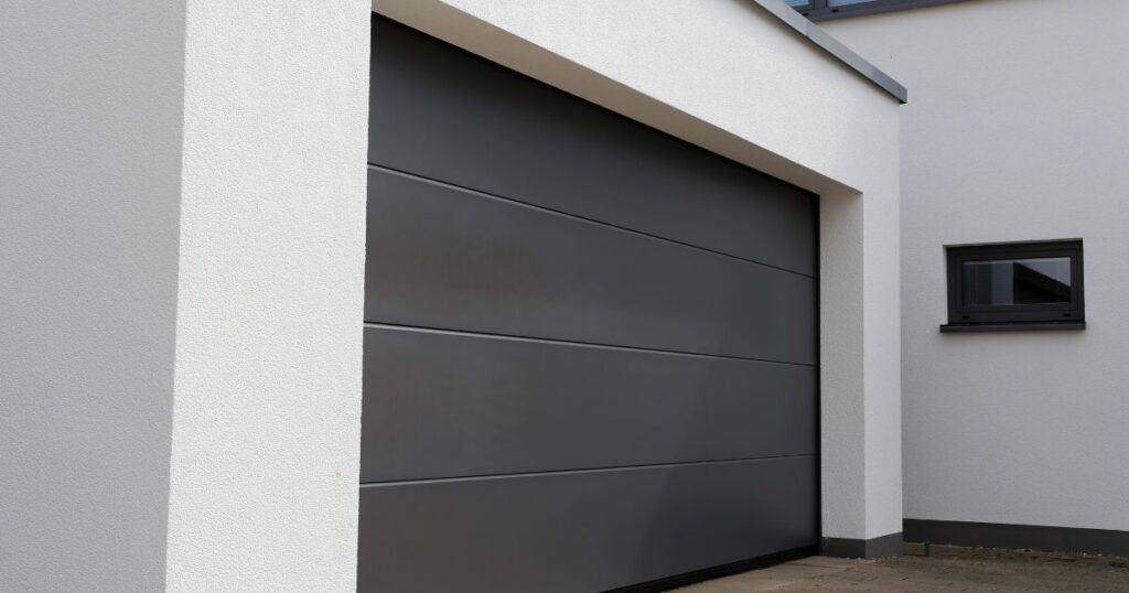 Homeowner reviewing garage door panel and insulation options during exterior renovation
