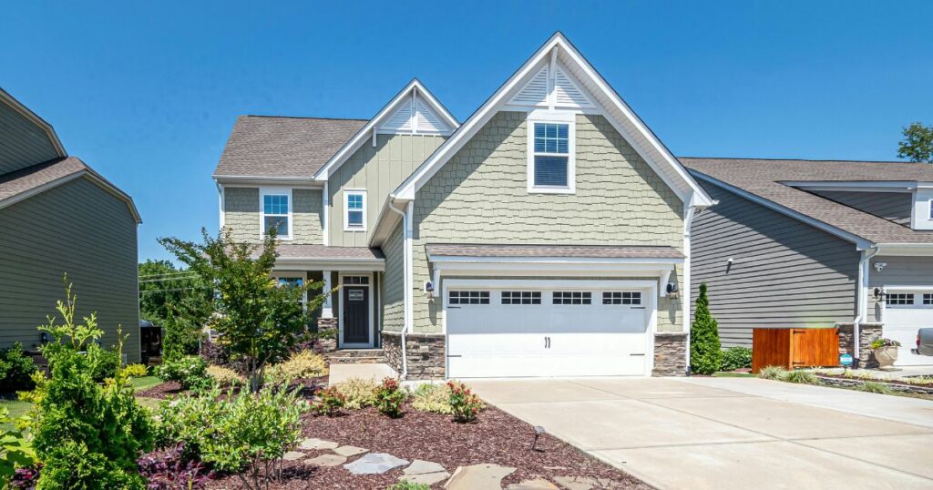 Homeowner comparing insulated garage door styles for Charleston exterior renovation project
