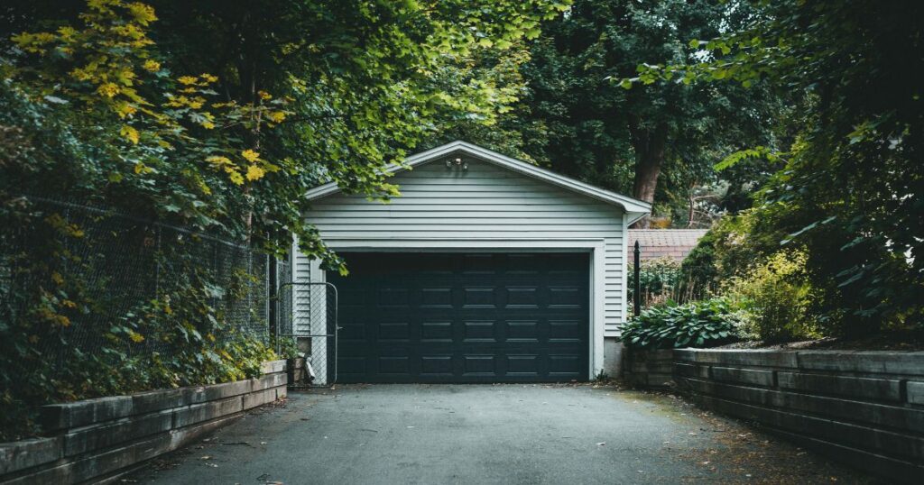 Garage door professional assessing material durability for humid and high-use property conditions