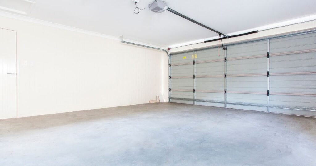 Specialist evaluating garage door material and insulation needs for humid outdoor conditions